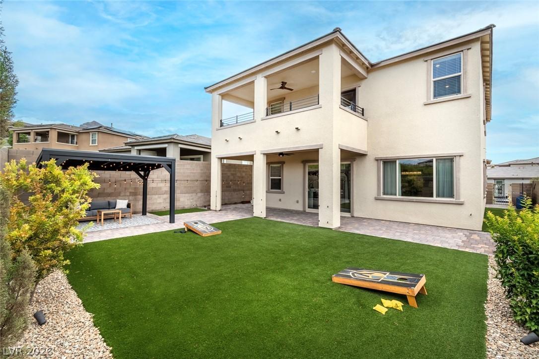 Image 2: A private yard with artificial turf and a covered