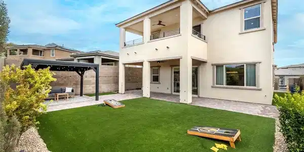 Image 2: A private yard with artificial turf and a covered