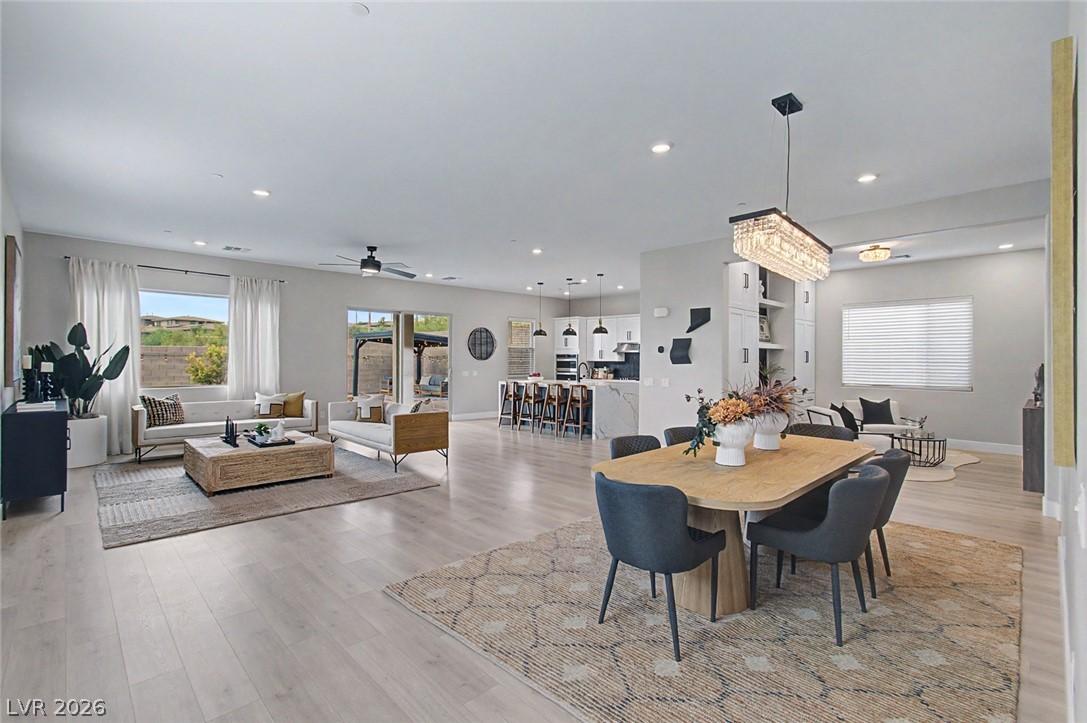 Image 4: An open-concept interior unites living, dining, an