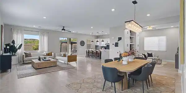 Image 4: An open-concept interior unites living, dining, an