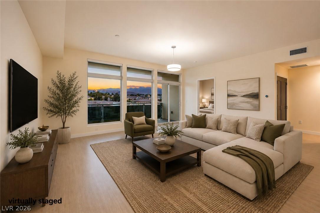 Image 4: City lights glimmer beyond the windows of this inv
