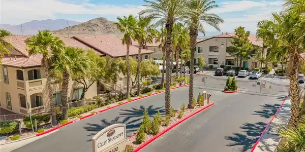 Image 2: Palm-lined entrance leads to a secure, desert-moun