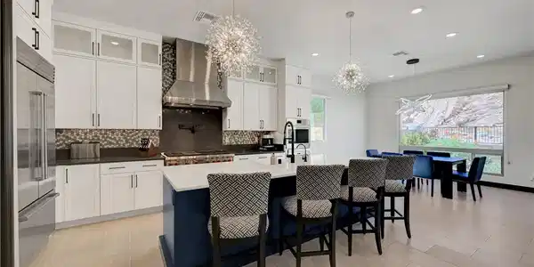 Image 3: An open kitchen layout boasts porcelain flooring a