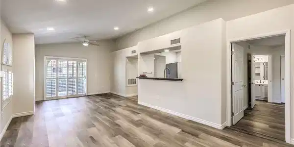 Image 2: A luminous living area showcases vaulted ceilings,