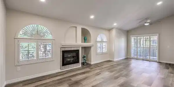 Image 4: A well-lit living space showcasing a fireplace wit