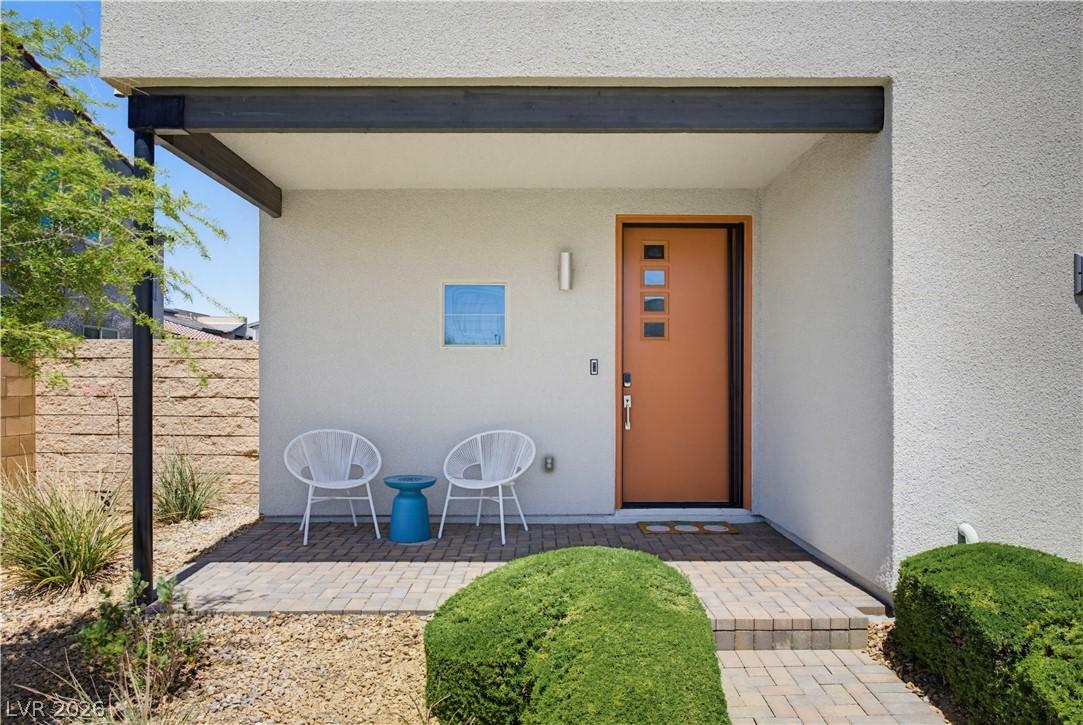 Image 3: A modern entry offers a stylish orange door and a