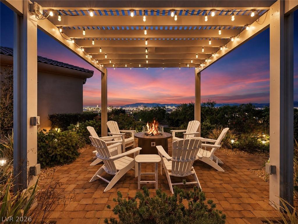 Image 3: An inviting pergola with string lights covers a br