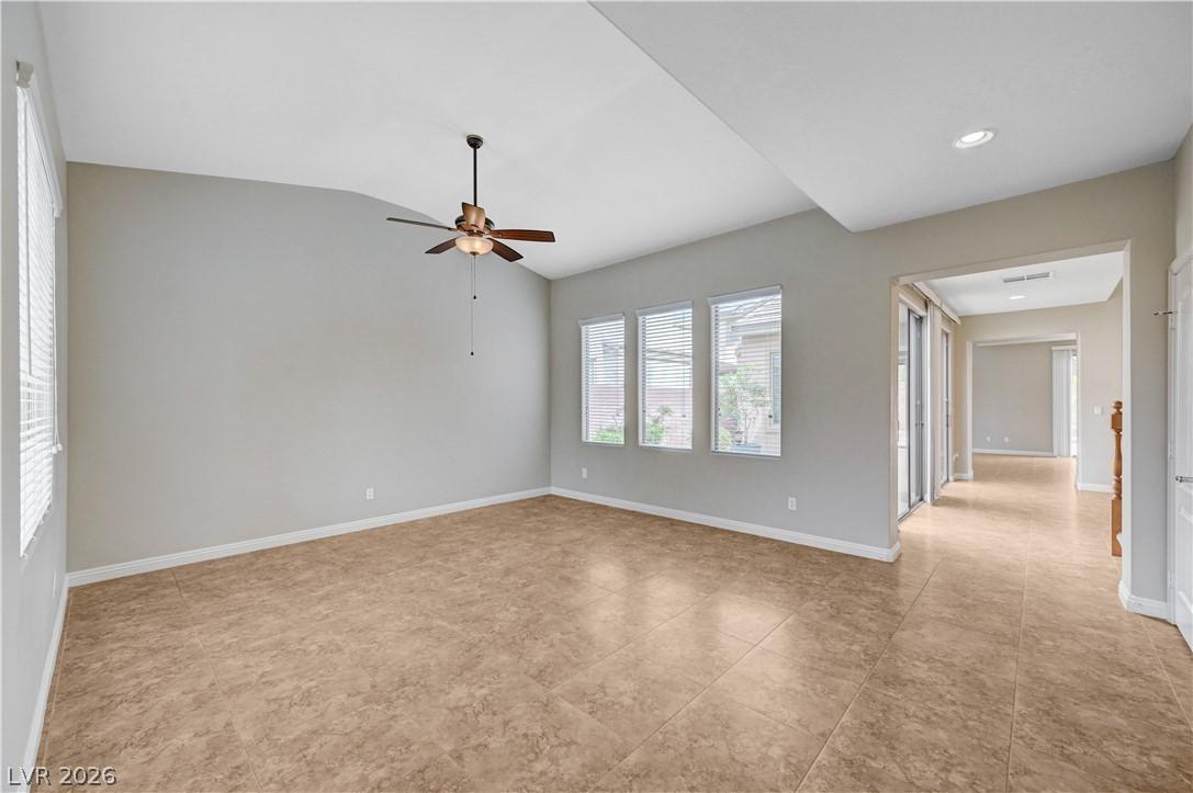Image 3: Formal living room with a ceiling fan and vaulted