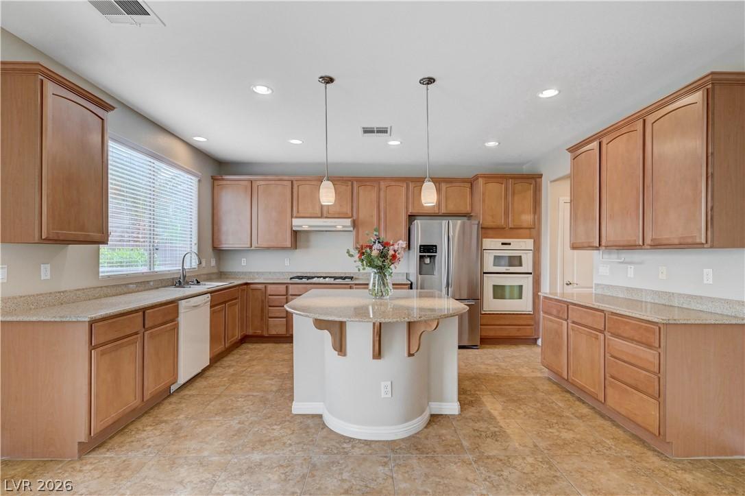 Image 4: Kitchen featuring decorative light fixtures, white