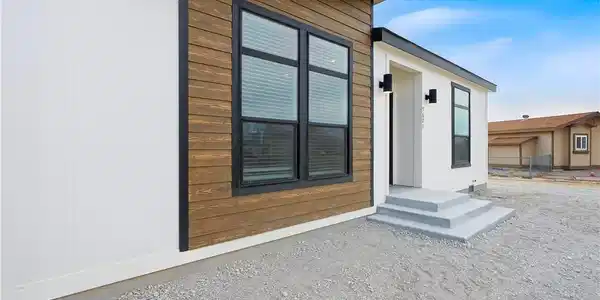 Image 4: Modern facade blending clean white siding with war