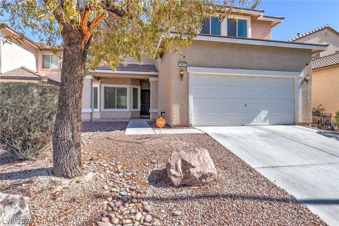 Image 2: A welcoming facade with desert landscaping and a d