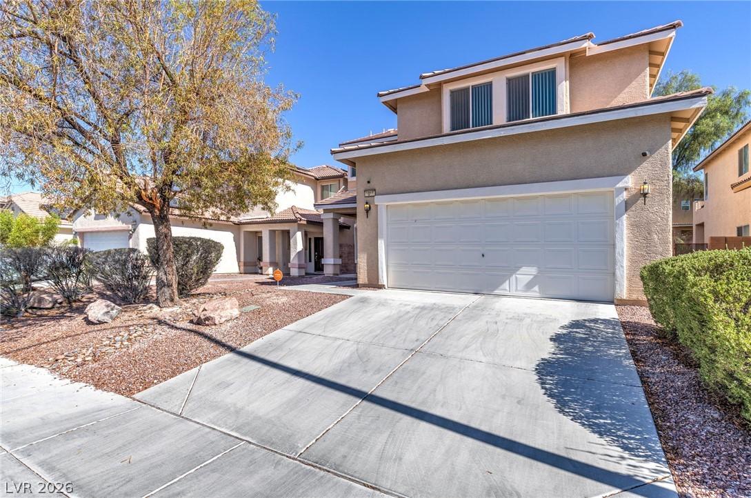Image 3: Concrete driveway leads to a welcoming two-story r