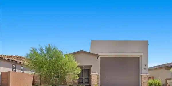 Image 2: A modern desert dwelling features a two-car garage