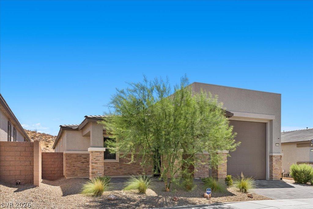 Image 3: A desert-friendly facade with stone accents and a