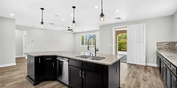 Image 4: Gleaming stone countertops and a spacious central
