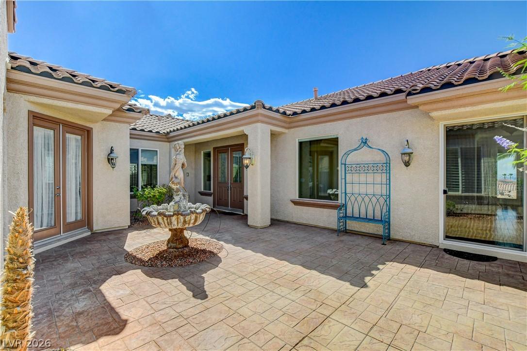 Image 4: A tranquil courtyard entry with a classical founta