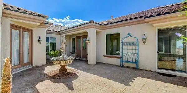 Image 4: A tranquil courtyard entry with a classical founta