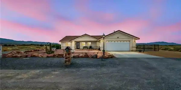 Image 2: A desert oasis with inviting curb appeal, this hom