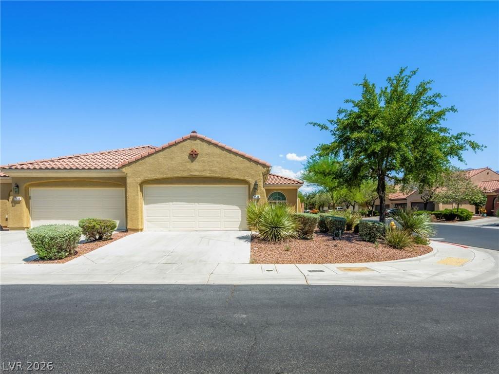Image 2: A well-maintained stucco home with a tile roof and