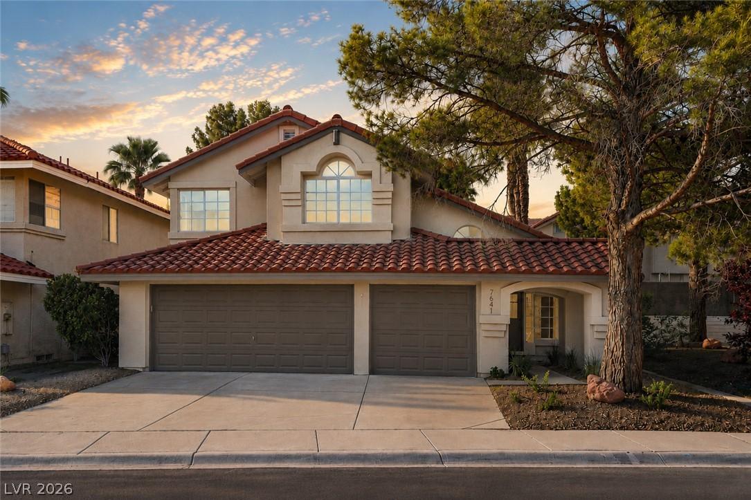 Image 2: Spanish-style architecture with a tile roof and st