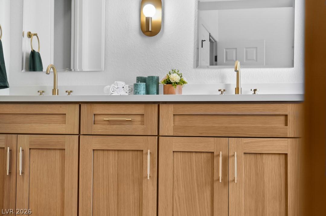 Image 4: Double vanity with sleek fixtures offers a refined