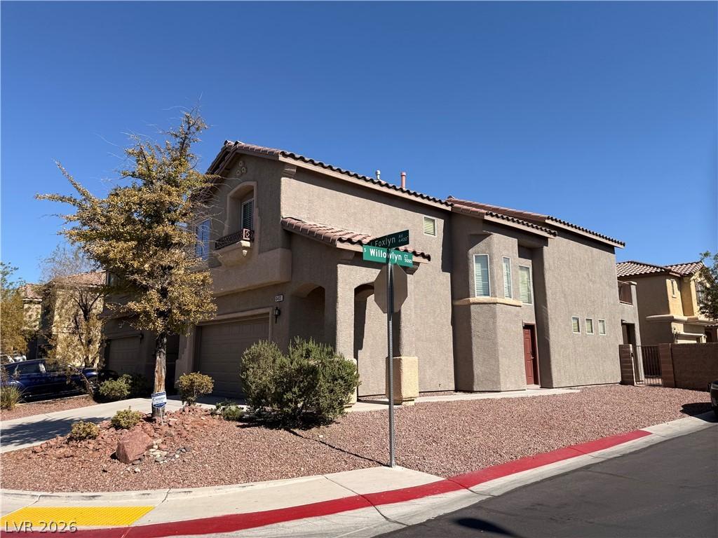 Image 3: A well-maintained corner residence boasts a stucco