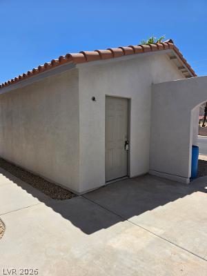 Image 3: A detached storage structure with a tiled roof and