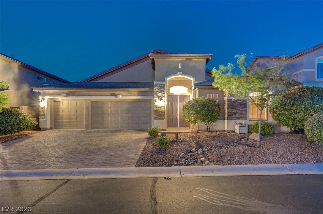 Image 2: An inviting exterior boasts a brick paver driveway
