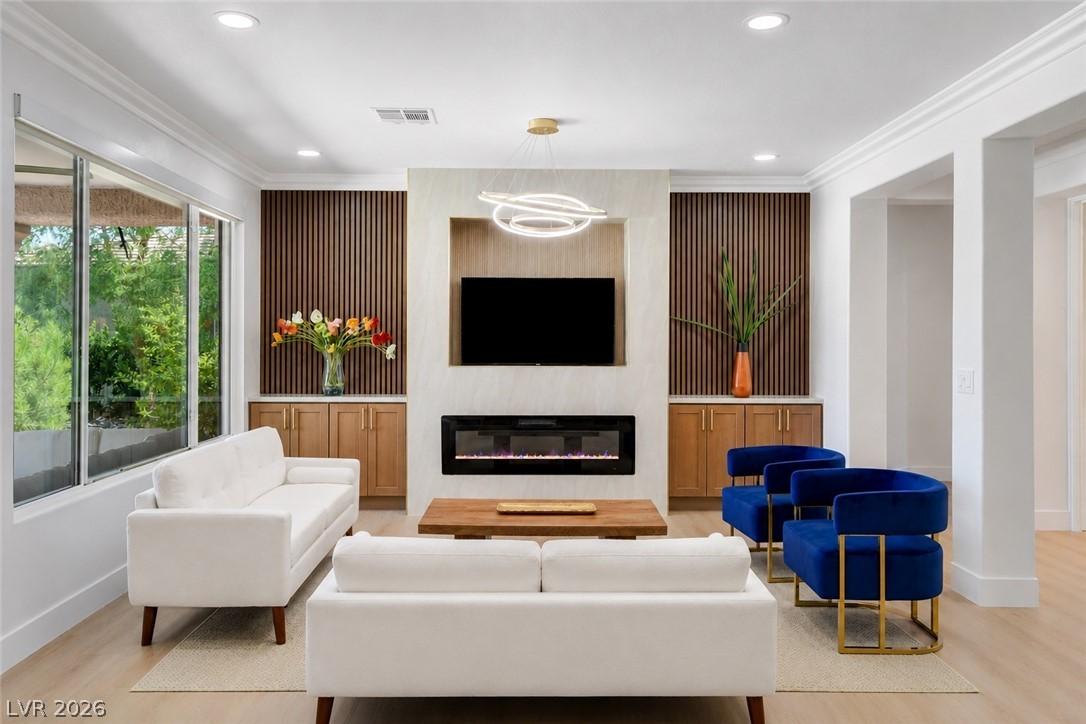 Image 1: The open-concept living area boasts abundant natur