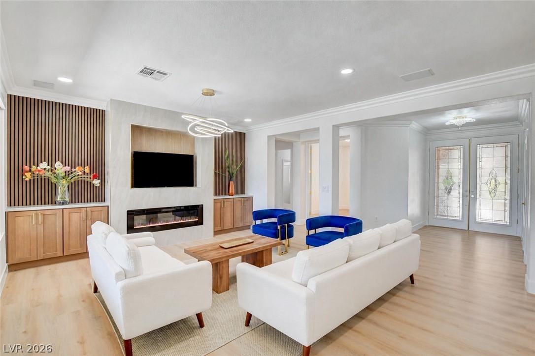 Image 3: Clean lines and a striking fireplace create a welc