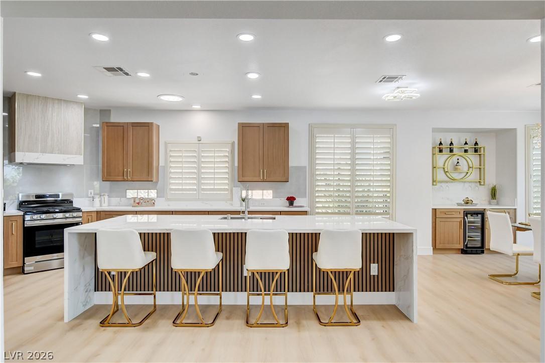 Image 4: A contemporary kitchen offers a spacious island wi