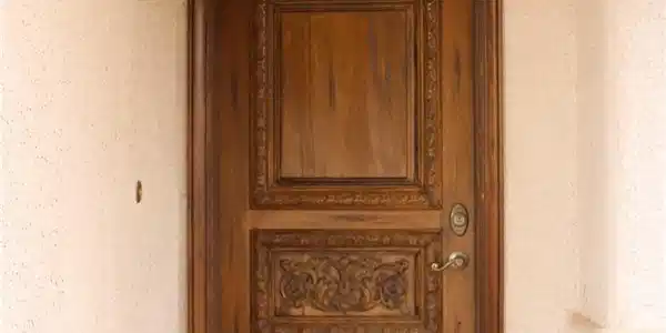 Image 3: Ornately carved wooden entry door creates a striki