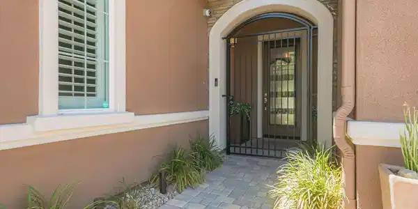 Image 4: An inviting stone pathway leads to a secure wrough