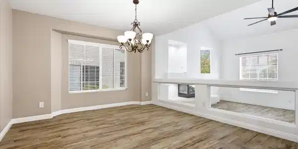 Image 3: Natural light floods this living space, featuring