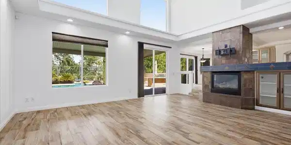 Image 4: An inviting kitchen with a granite island, rich ca