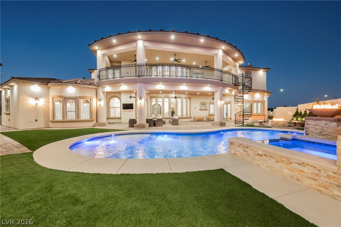 Image 1: An inviting backyard oasis offers a sparkling pool