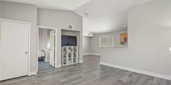 Image 3: Angled ceilings and durable vinyl flooring define