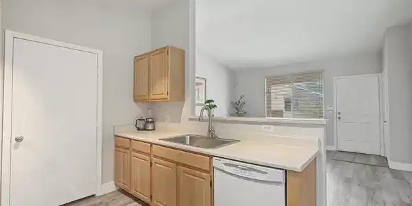 Image 4: An open pass-through window connects the kitchen t
