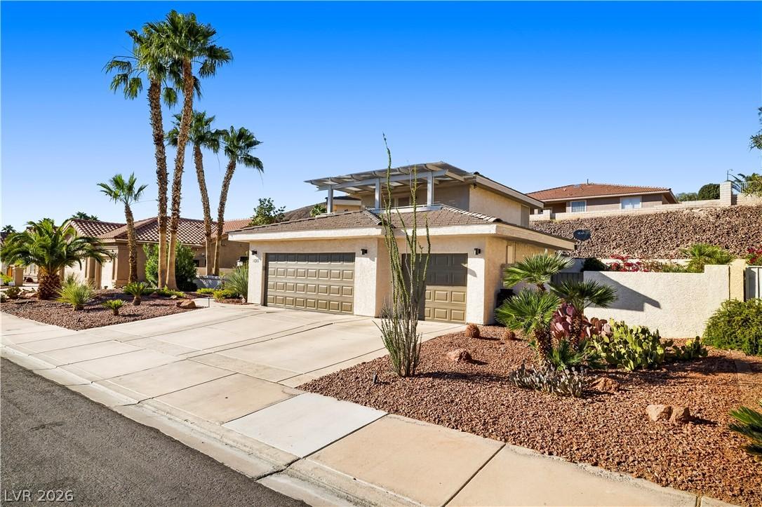 Image 3: A desert-friendly landscape surrounds this residen