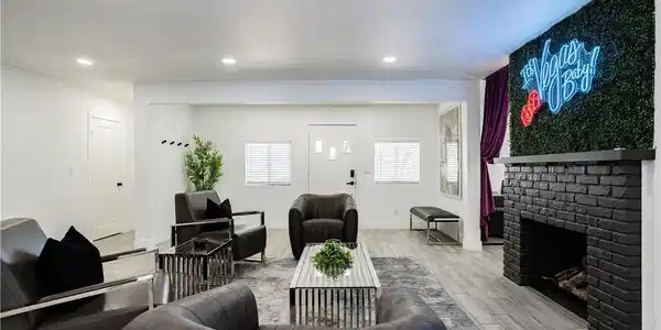 Image 3: A well-lit sitting area features light wood-look f