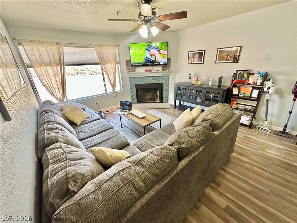 Image 2: Living area with ceiling fan, wood finished floors
