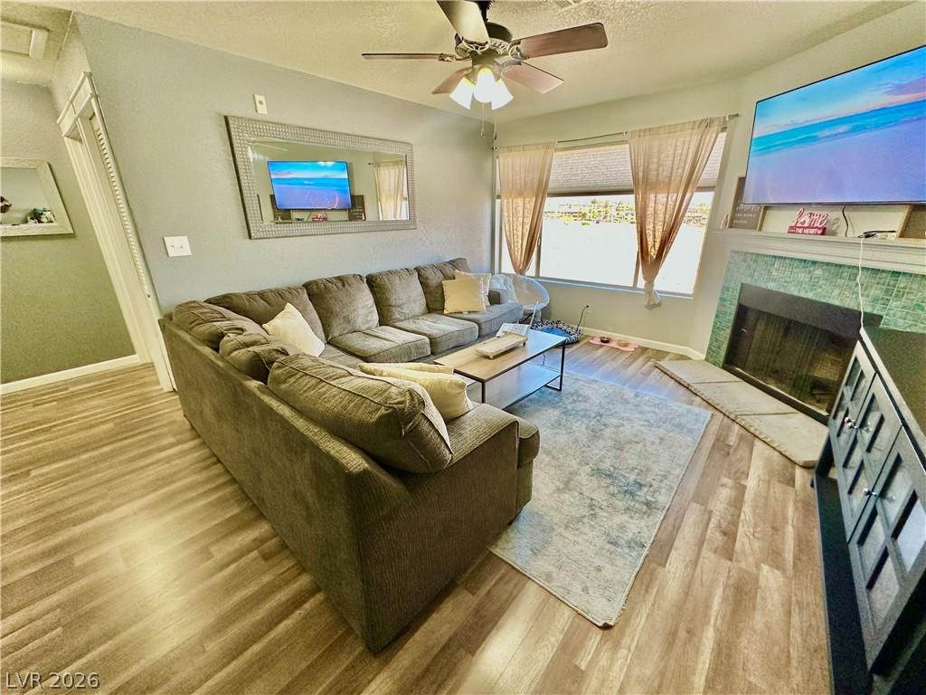 Image 3: Living area with baseboards, wood finished floors,