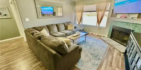 Image 3: Living area with baseboards, wood finished floors,