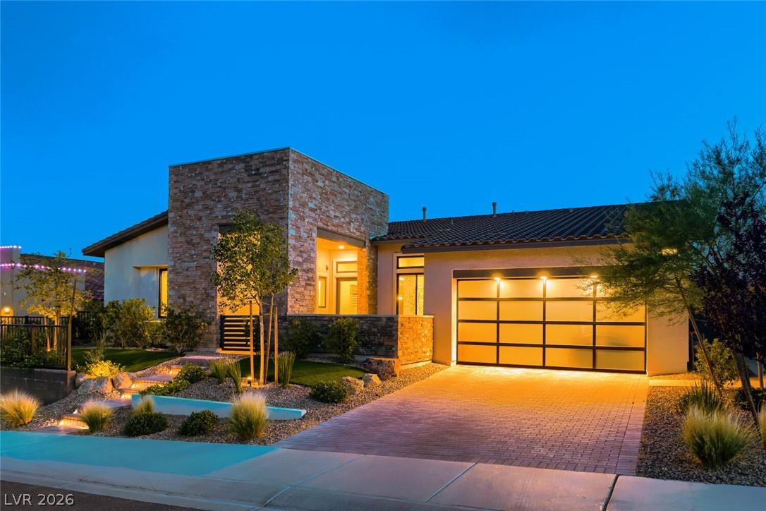 Image 4: Modern architecture is illuminated at dusk, showca