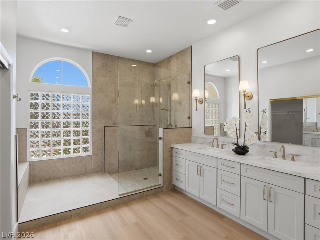Image 4: Luxurious primary bath with dual vanities and a sp