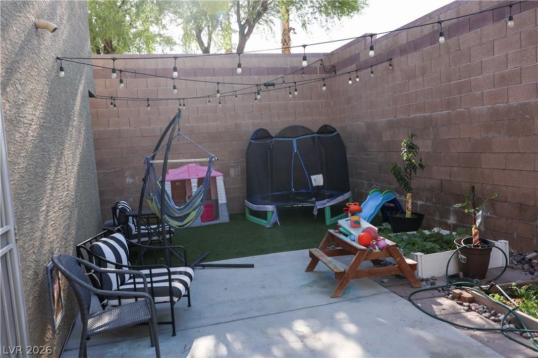 Image 2: A private, walled backyard sanctuary with concrete