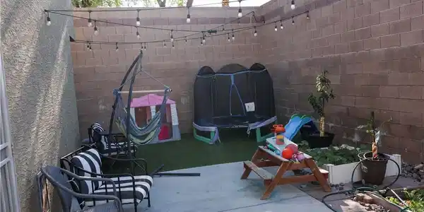 Image 2: A private, walled backyard sanctuary with concrete