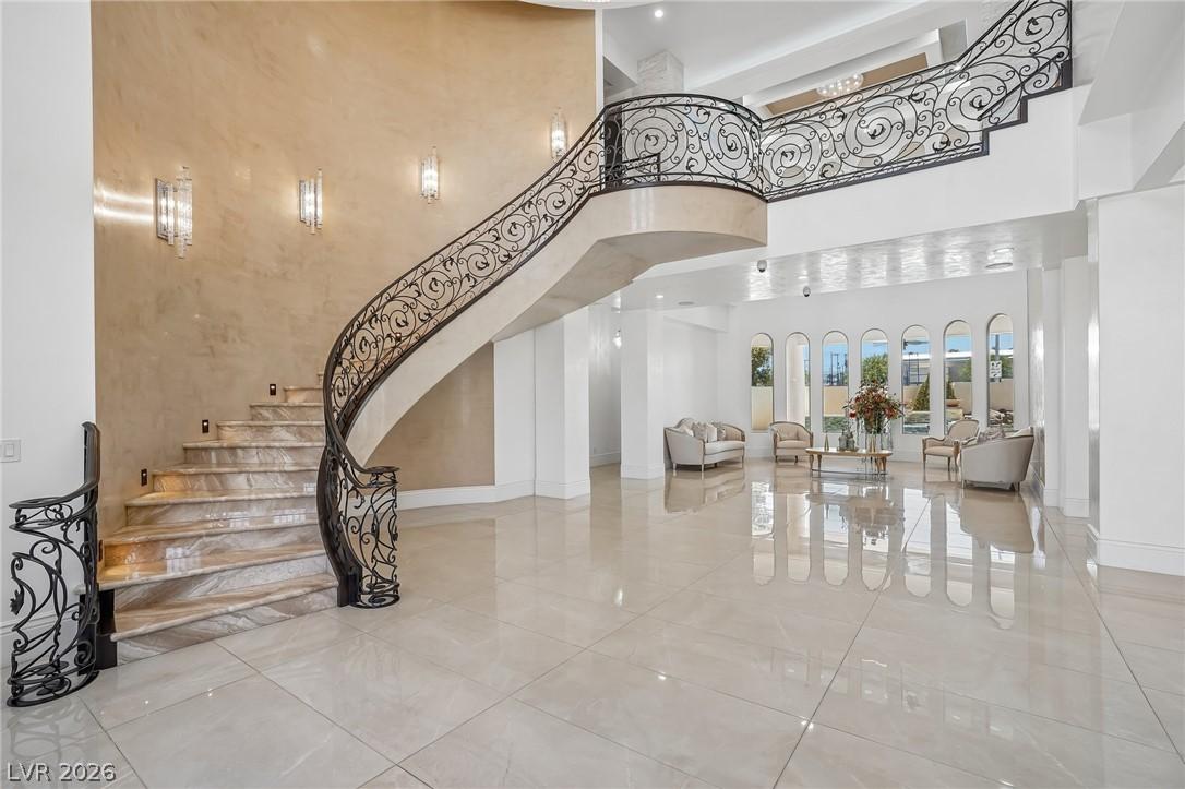 Image 3: Grand marble staircase with ornate iron railings a