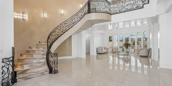 Image 3: Grand marble staircase with ornate iron railings a