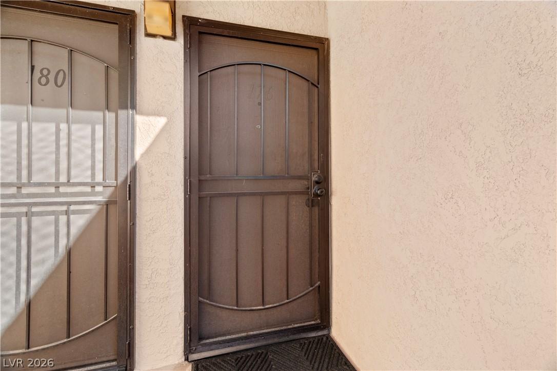 Image 4: View of exterior entry featuring stucco siding
